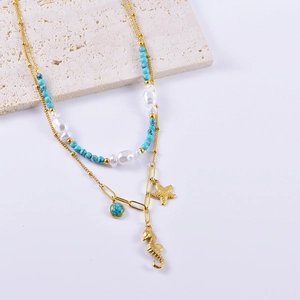 Detailed shot of double-layer necklace with seahorse, starfish charms and pearls