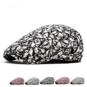 Retro vintage newsboy cap with black and white floral print and adjustable metal side buckle