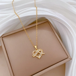 Detailed macro view of a gold heart pendant with cubic zirconia on a luxury jewelry box