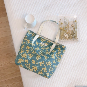 Floral cotton mini tote bag with yellow berry pattern and zipper on white quilted background