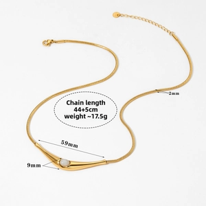 Detail view of gold snake chain necklace with curved pendant and measurements in cm