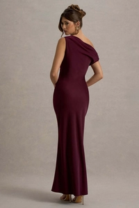Macro detail of wine red one-shoulder evening gown with premium drape and slim fit cut