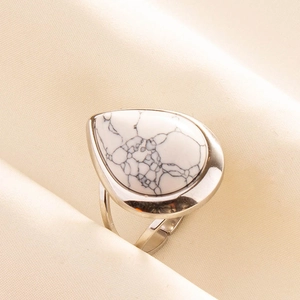 Close-up of teardrop white turquoise stone set on adjustable stainless steel ring