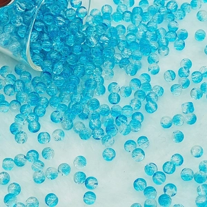 Macro shot of sky blue crackle glass beads for DIY jewelry making and bracelets