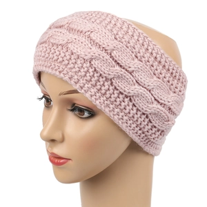 Macro detail of pink cable knit texture on a winter headband for ear protection