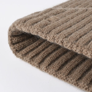Brown rib-knit beanie made of warm wool material with distressed street style detail