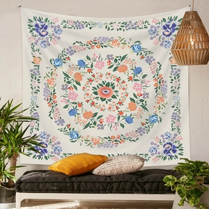 Detail of bohemian mandala tapestry featuring colorful floral patterns on a wall