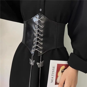 Fashionable black corset belt with silver butterfly chain and elastic band on model