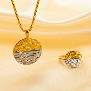 Hammered two-tone gold and silver circular pendant necklace and ring set on silk