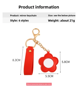 Detail showing red flower-shaped PU leather mirror keychain with gold hardware and dimensions