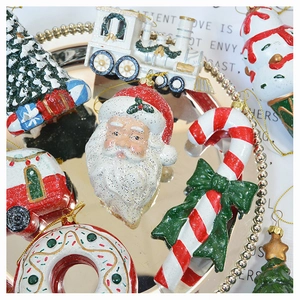 Close-up of festive Christmas tree ornaments including Santa, candy canes and a red car