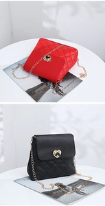 Detail of heart-shaped metal clasp and quilted texture on chain crossbody bags