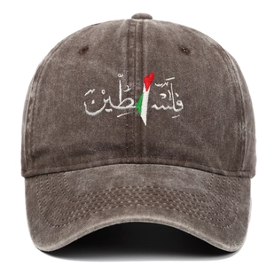 Detailed close-up of embroidered Arabic text on vintage washed dark brown baseball cap