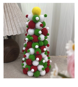 Detailed view of red, white and green polyester pompom Christmas tree tabletop decoration
