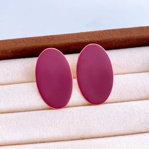 Minimalist oval stud earrings with burgundy enamel and fine golden metal borders