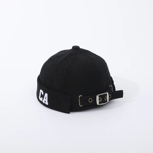 Detail of black corduroy beanie with white CA embroidery and adjustable metal buckle