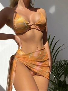 Detailed view of orange marble bikini set with ribbed texture and matching sarong skirt
