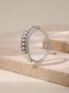 Detail view of adjustable silver ring with white pearls and small sparkling crystals