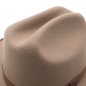 Detailed close-up of brown wool felt fedora with ribbon band and premium textured finish