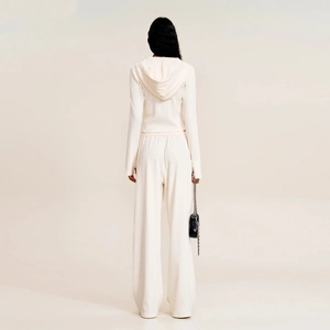 Rear view of white knit hoodie and wide-leg sports pants with vertical ribbed texture
