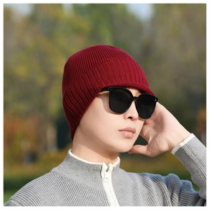 Detailed view of the dark red ribbed knit texture and thick winter beanie material