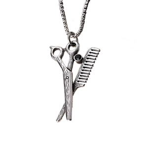 Polished stainless steel scissors and comb pendant necklace with black gemstone inlay