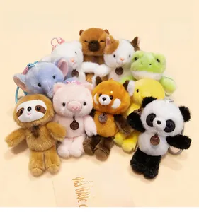 Close-up of soft plush animal keychains including panda, elephant and frog with tags