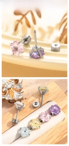 Detailed view of colorful star-shaped zircon earrings with screw backs in silver titanium steel