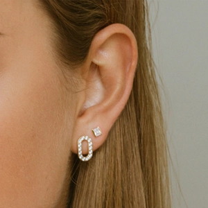 Macro detail of S925 silver gold cobra chain earrings with stars moon and pavé crystals