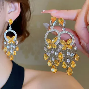 Elegant butterfly drop earrings with yellow crystal tassels and silver needle setting