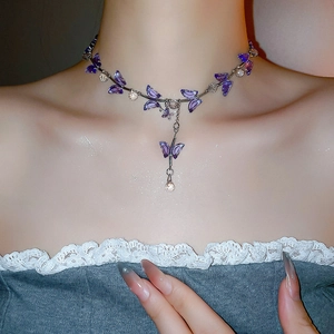 Close-up of elegant crystal butterfly necklace featuring purple stones on a silver chain