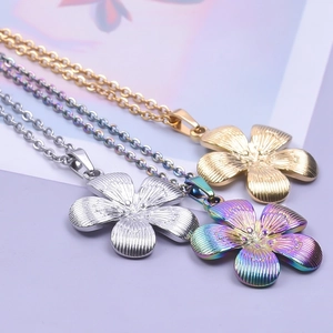 Close-up of five-petal flower pendants in gold, silver, and rainbow steel finishes