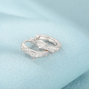 Macro shot of S925 sterling silver star hoop earrings featuring sparkling zircon inlay details