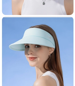 Detail view of light blue UPF50+ sun visor hat on female model for UV protection