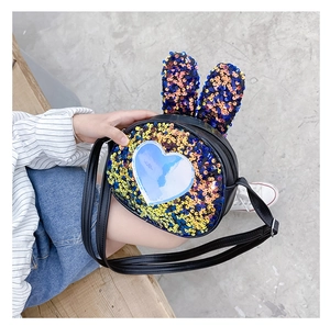 Detail of gradient blue and yellow sequin girls' bunny ear bag with heart patch