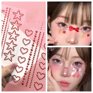 Macro detail of red self-adhesive facial rhinestone stickers with heart and star shapes