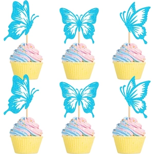 Set of 6 blue glitter butterfly cupcake toppers on colorful frosted cakes in a clean layout