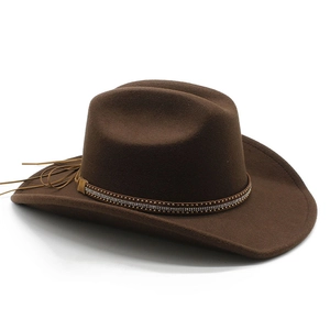 Detail of dark brown cowboy felt hat with gold studs on decorative band and leather tassels