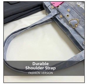 Detail of light blue denim tote bag with durable wide straps and gold heart hardware