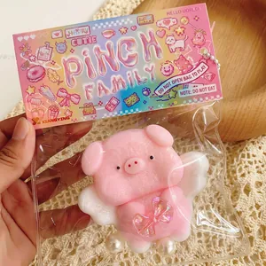 Pink pig stress toy with wings in sealed bag packaging with hanging chain