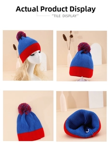 Detail view of knit beanie with red and blue color block design and fluffy pompom top