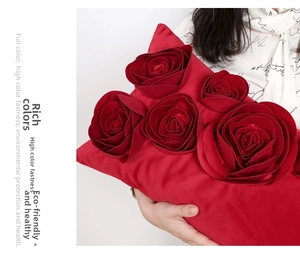 Detail of red velvet 3D rose throw pillow showing plush petals and soft texture