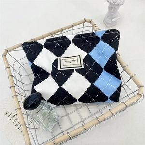 Detail of blue argyle canvas makeup bag with zipper and Pleasant Time label