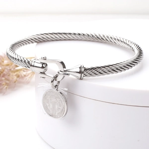 Detailed macro shot of twisted stainless steel cable bracelet with U-shaped horseshoe clasp