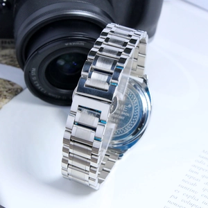 Close-up of the silver stainless steel strap and case back of a vintage men's quartz watch