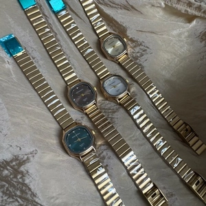 Elegant collection of women's square quartz watches with colorful dials on silk fabric