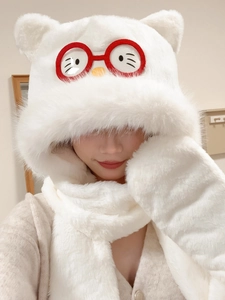 Detailed texture of white plush hooded scarf with cute ears and cartoon eye embroidery