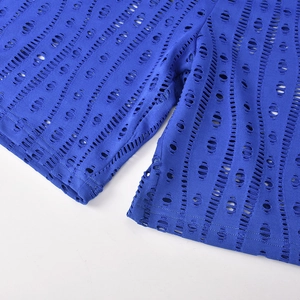 Close-up of royal blue bodysuit featuring intricate cutout textures and ripped detailing