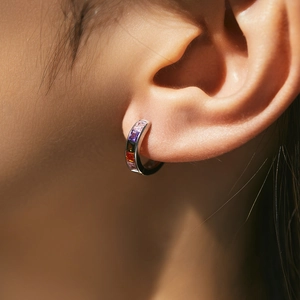 Rainbow gemstone s925 silver hoop earring worn by a model in a close-up shot