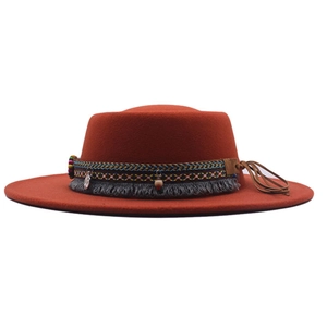Detail of burnt orange bohomian fedora with ethnic embroidery and tassel fringe